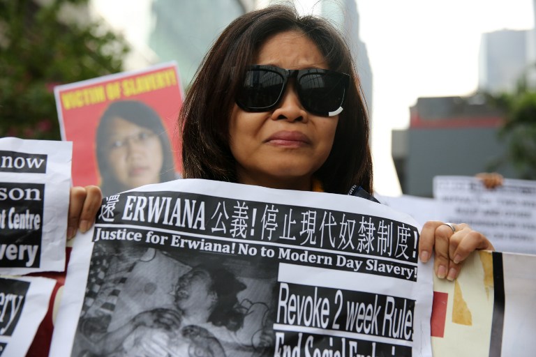 A member of a support group for Indonesian maid Erwiana Sulistyaningsih, who was abused by her Hong Kong employers, protests outside the Wanchai law courts in Hong Kong on December 8, 2014.  Former Indonesian maid Sulistyaningsih takes the stand for the first time to detail the months of abuse she allegedly suffered at the hands of her Hong Kong employers in a case which sparked international outrage.  AFP 