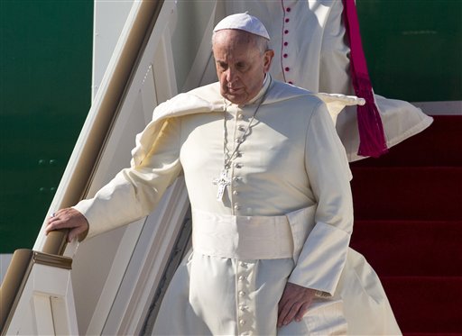 Pope Francis walks down an airstair upon arrival in Colombo, Sri Lanka, Tuesday, Jan. 13, 2015. Pope Francis has arrived safely in Sri Lanka for the first leg of a weeklong trip to Asia, received at the airport by newly elected President Maithripala Sirisena and Cardinal Malcolm Ranjith. AP