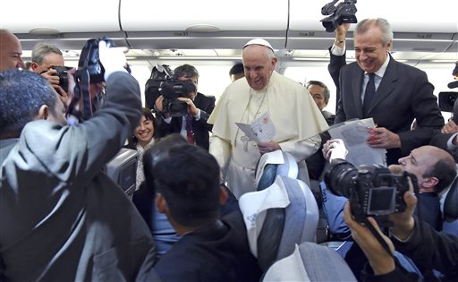 Pope Francis meets reporters en-route to Colombo, Sri Lanka, Monday, as he commence his Asian tour, Monday, Jan. 12, 2015. AP