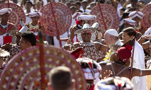Pope Francis is received by colorful Sri Lankan dancers upon arrival at Colombo's International airport in Colombo, Sri Lanka, Tuesday, Jan. 13, 2015. AP