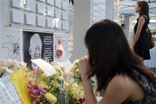 Mourners view condolence messages on the death of Singapore's founding prime minister Lee Kuan Yew outside the Istana or presidential palace Tuesday, March 24, 2015 in Singapore. 