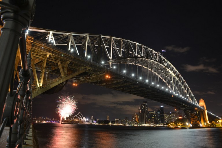 Fireworks go off at the Sydney Harbour Bridge and Opera House to signal the start of the Earth Hour environmental campaign, among the first landmarks around the world to dim their lights for the event on March 28, 2015. Lights will go out in some 7,000 cities and towns from New York to New Zealand for Earth Hour to raise awareness of the need for sustainable energy use, and this year also to demand action to halt planet-harming climate change. AFP 