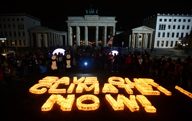 Candles in paper bags are placed to form the lettering "Save our climate, Now" in front of the Brandenburger Gate in Berlin during the the global climate change awareness campaign "Earth Hour" on March 28, 2015. Millions are expected to take part around the world in the annual event organised by environment conservation group WWF, with hundreds of well-known sights including the Eiffel Tower in Paris and the Seattle Space Needle set to plunge into darkness for an hour to highlight the plight of the planet.  AFP