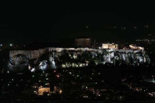 This picture shows the ancient Temple of Parthenon atop Acropolis hill in partial darkness during the Earth Hour initiative in Athens on March 28, 2015. Millions are expected to take part around the world in the annual event organised by conservation group WWF, with hundreds of well-known sights set to plunge into darkness.  AFP 