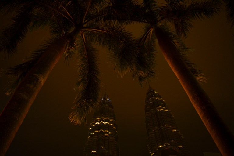 A general view shows the Malaysia's landmark Petronas Twin Towers in Kuala Lumpur after the lights had been switched off for earth hour on March 28, 2015. Lights will go out in some 7,000 cities and towns from New York to New Zealand for Earth Hour to raise awareness of the need for sustainable energy use, and this year also to demand action to halt planet-harming climate change. AFP 