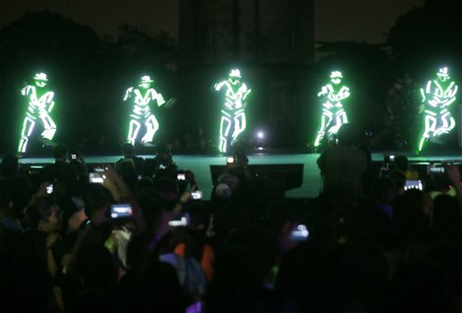 Performers wearing luminous costumes entertain the crowd during the symbolic switching off of the lights known as Earth Hour Saturday, March 28, 2015 at Quezon city northeast of Manila, Philippines. Earth Hour, participated in by more than 7,000 cities and townships worldwide, urges households and citizens to switch off their electricity for one hour to help reduce Carbon emissions to help save planet Earth. AP