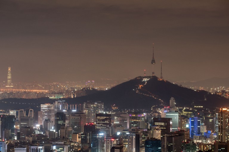 A general view shows the Seoul city skyline and the landmark Namsan tower (R) during 'Earth Hour' on March 28, 2015. Lights will go out in some 7,000 cities and towns from New York to New Zealand for Earth Hour to raise awareness of the need for sustainable energy use, and this year also to demand action to halt planet-harming climate change. AFP 