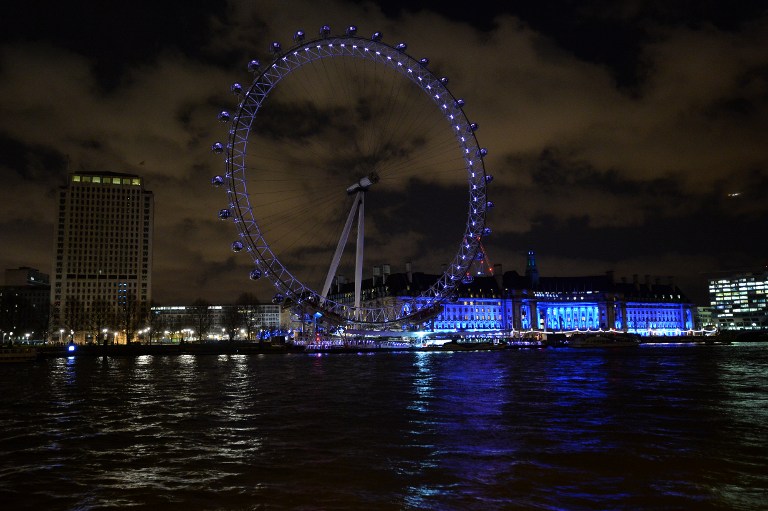 A picture taken on March 28, 2015  in central London shows The London Eye in central London illuminated ahead of Earth Hour campaign. Millions are expected to take part around the world in the annual event organised by conservation group WWF, with hundreds of well-known sights set to plunge into darkness. AFP 