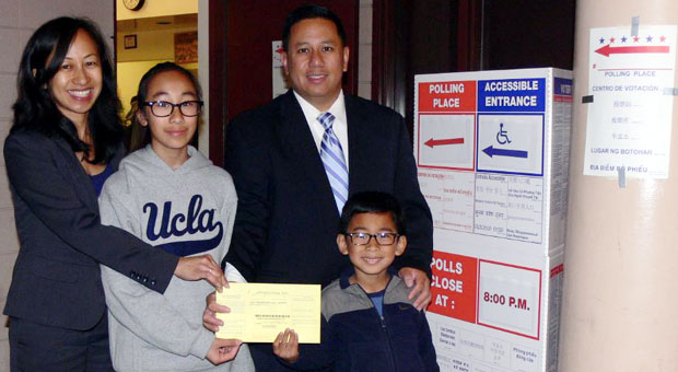 Cerritos Mayor Mark Pulido and his wife Gloria pose with their children for a photo after they cast their votes on March 3. 
