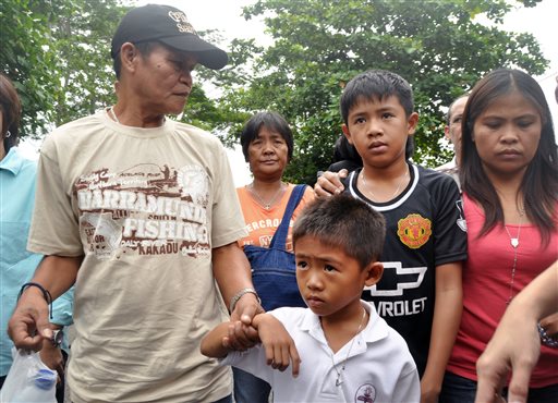Family members of Mary Jane Veloso, a Filipino woman on death row for drug offenses, from left to right, father, Cesar, mother Celia, sons Mark Daniel and Mark Darren and sister Marites, walk upon arrival at Wijayapura ferry port to to cross to the prison island of Nusakambangan, in Cilacap, Central Java, Indonesia, Saturday, April 25, 2015. AP