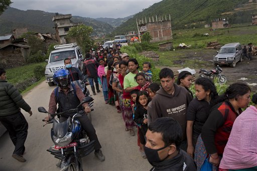 Nepalese villagers stand in a queue to receive food being distributed in Sakhu, on the outskirts of Kathmandu, Nepal, Wednesday, April 29, 2015. AP