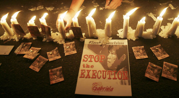 Protesters light candles as they continue their vigil for a second day to plead the Indonesian Government to stop the execution of convicted Filipino drug trafficker Mary Jane Veloso, outside the Indonesian Embassy in the financial district of Makati city east of Manila, Philippines, Monday, April 27, 2015. AP