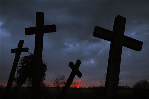 Crosses at a war memorial stand in front of the dawning sky at Muhi, 167 kms northeast of Budapest, Hungary, on Easter Sunday, April 5, 2015. AP