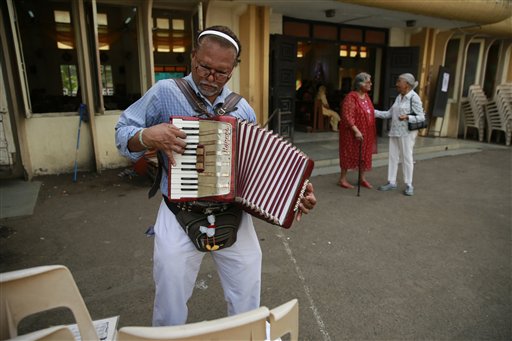A man plays the accordion after easter mass at a Church in Mumbai, India, Sunday, April 5, 2015. Christians around the world are celebrating Easter commemorating the day when according to Christian tradition Jesus was resurrected in Jerusalem two millennia ago. AP