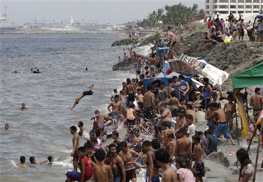 Filipinos swim in the polluted waters of Manila's bay, Philippines as they celebrate Easter Sunday April 5, 2015. Despite a city-imposed swimming ban, many Filipinos set up makeshift tents and swam along the bay to cool themselves from summer's sweltering heat. AP