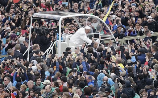 Pope Francis salutes faithful in St. Peter's square at the Vatican, Sunday, April 5, 2015. AP