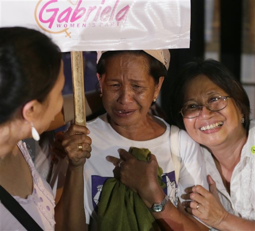 Protesters, who kept vigil at the Indonesian Embassy in the financial district of Makati city east of Manila, Philippines, celebrate following an announcement of the delay of the execution of convicted Filipino drug trafficker Mary Jane Veloso in Indonesia, before dawn Wednesday, April 29, 2015.  AP PHOTO/BULLIT MARQUEZ