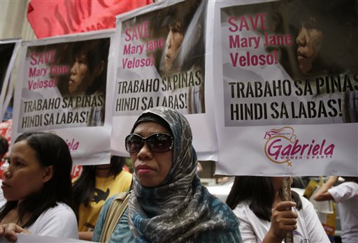 Protesters display placards during a rally at the Indonesian Embassy in the financial district of Makati city, east of Manila, Philippines, to appeal to Indonesian government to spare the life of convicted Filipino drug trafficker Mary Jane Veloso Friday, April 24, 2015. AP