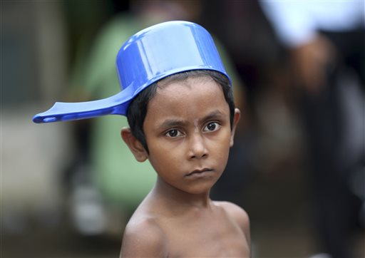 An ethnic Rohingya child prepares to take a shower at a temporary shelter in Bayeun, Aceh province, Indonesia, Saturday, May 23, 2015. AP
