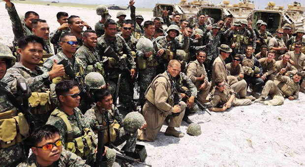 GAMES OVER  No longer sporting grim and grimy faces, Philippine and US Marines, some of whom managed to smile, pose for a souvenir photo after their live fire RP-US Balikatan military exercises at Crow Valley in Capas, Tarlac province. The notorious Crow Valley was the gunnery range of the former US Air Base in Clark Field, then the largest outside the United States.  RAFFY LERMA