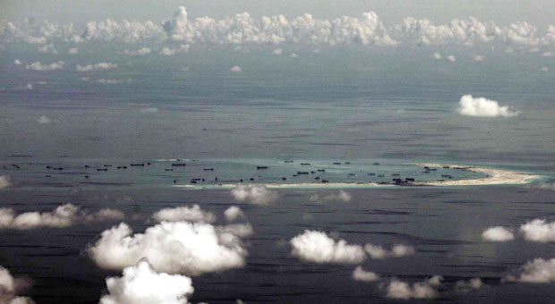 OCCUPIED ISLAND This photo taken from a military plane shows the ongoing reclamation on Mischief Reef, one of the reefs being claimed by China and the Philippines, in the Spratly Islands, in the South China Sea. China said it would complete land reclamation projects in disputed territories as planned within “upcoming days.” AP