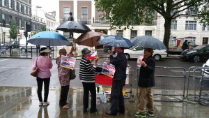 UK Filipino community leaders stand protesting in the rain outside Embassy of China, London-1