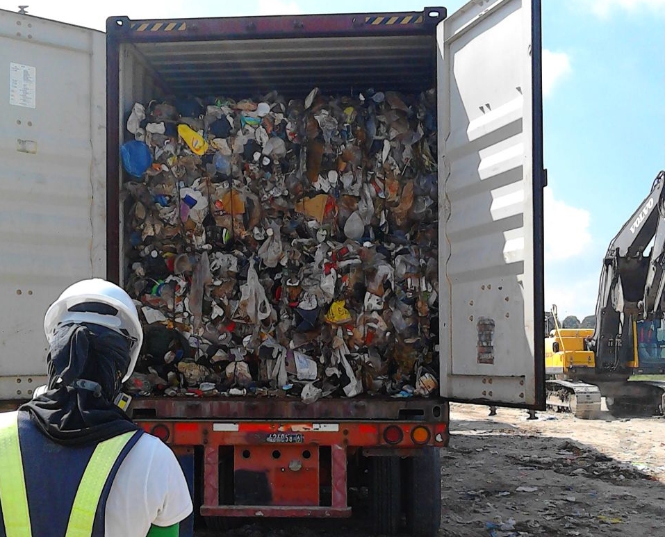 TRASH packed in container vans that were shipped from Canada in 2013 are unloaded at the sanitary landfill of the Metro Clark Waste Management Corp. in Capas, Tarlac.  PHOTO COURTESY OF MCWMC