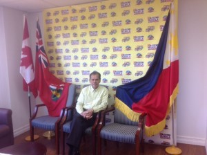 Mang Rollie Mangante flanked by the flags of Canada, Ontario, and the Philippines, his triple inspiration for offering Taste of Manila to the world.