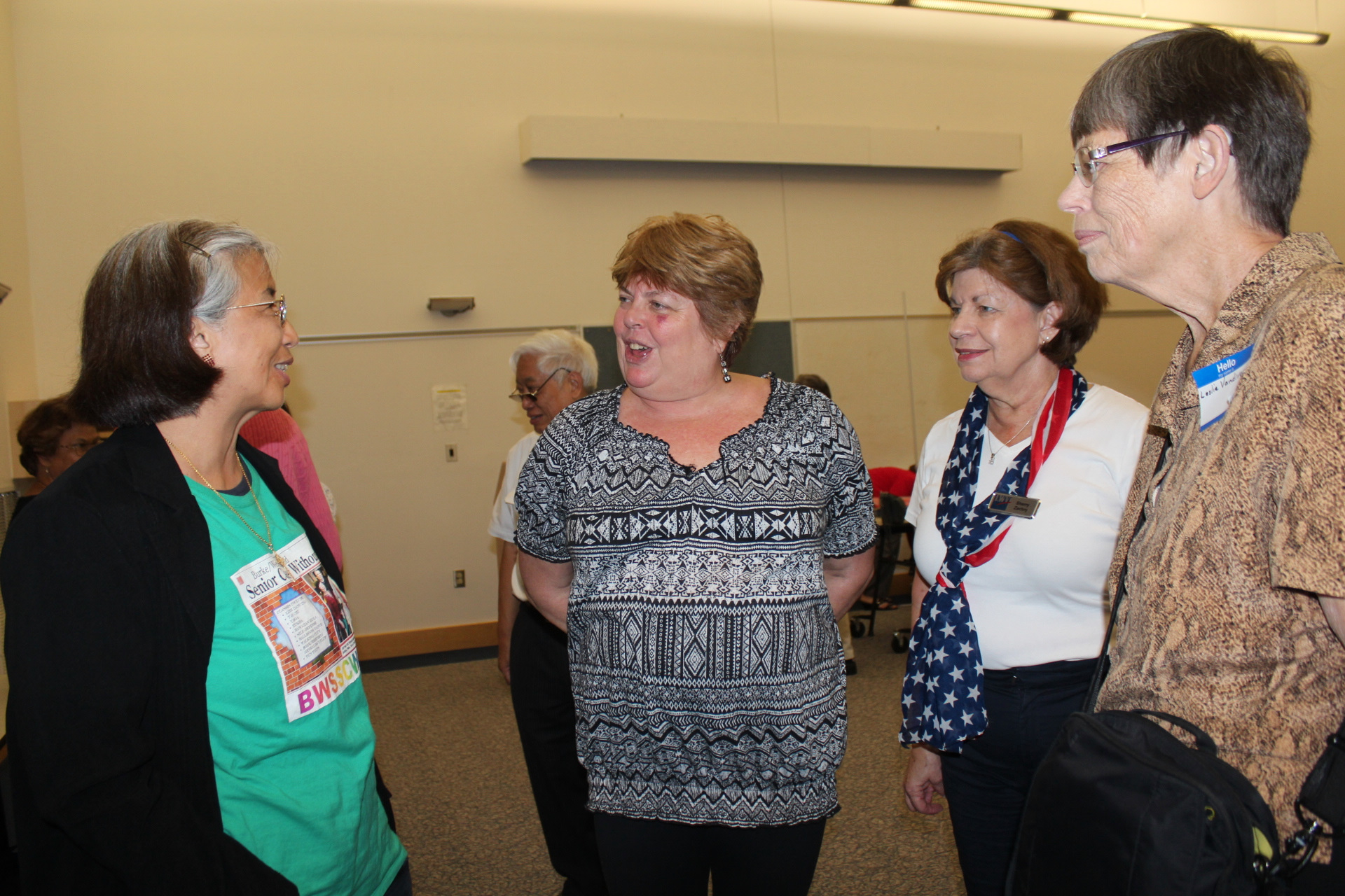 Cora Foley (left) engages in a post-candidates forum conversation with members of the League of Women Voters, from right, Leslie Vandivere, Sherry Zachry and Dianne Blais.