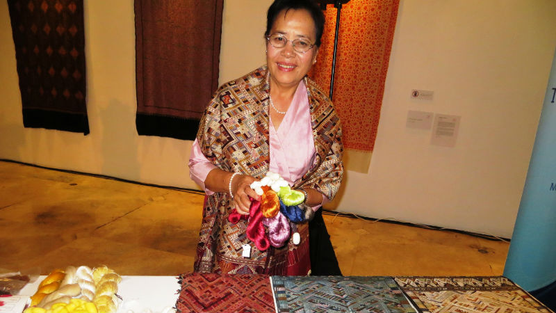 KOMMALY CHANTHAVONG of Laos, one of the five Ramon Magsaysay Awardees for 2015, scoops an armful of silk cocoons and spun silk thread dyed naturally in various colors and shows off hand-woven silk fabric with intricate designs. She was awarded for reviving the ancient Laotian art of silk weaving that gives livelihood for thousands of poor, war-displaced Laotians and for preserving her country's priceless cultural treasure. (Photo by Ceres P. Doyo)