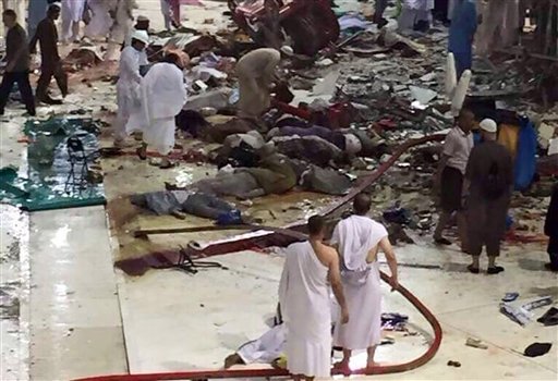 Pilgrims and first responders gather at the site of a crane collapse that killed dozens inside the Grand Mosque in Mecca, Saudi Arabia, Friday, Sept. 11, 2015. The accident happened as pilgrims from around the world converged on the city, Islam's holiest site, for the annual Hajj pilgrimage, which takes place this month. (AP Photo)