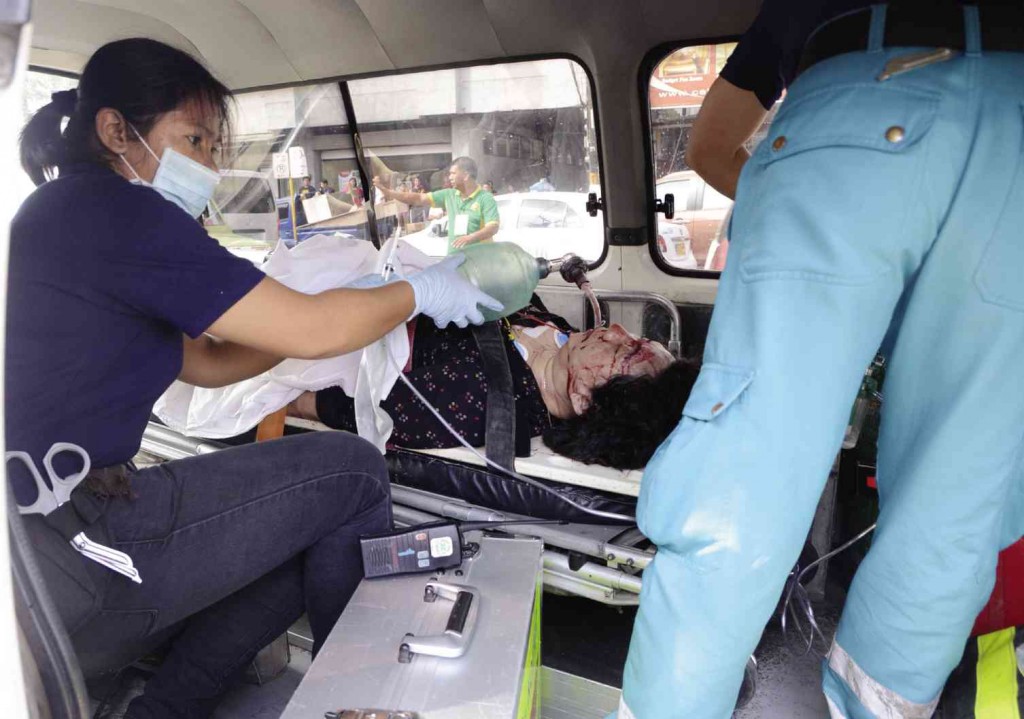 FIGHTING FOR LIFE Hui Li, a finance officer of the Chinese Consul Office who was shot in Lighthouse Restaurant, gets medical aid in an ambulance. Hui later died in a hospital. CHRISTIAN MANINGO / CEBU DAILY NEWS 