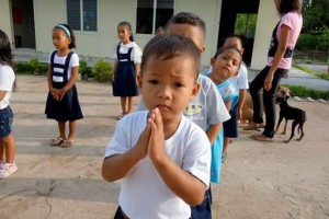 a praying and hoping school child in Pag-asa Islands