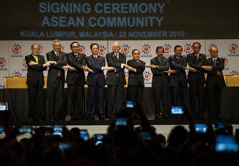 (L-R) Philippine President Benigno Aquino, Singapore Prime Minister Lee Hsien Loong, Thailand's Prime Minister Prayut Chan-O-Cha, Vietnam's Prime Minister Nguyen Tan Dung, Malaysia's Prime Minister Najib Razak, Laos Prime Minister Thongsing Thammavong, Brunei Sultan Hassanal Bolkiah, Cambodia's Prime Minister Hun Sen, Indonesia's President Joko Widodo and Myanmar President Thein Sein join hands together as they pose for a group photo after the Signing Ceremony as part of the 27th Association of Southeast Asian Nations ( ASEAN ) Summit at the Kuala Lumpur convention center on November 22, 2015. Terrorism and territorial tensions are expected to dominate discussions when Asia-Pacific leaders reconvene for a fresh round of summitry in Malaysia on November 21. AFP PHOTO / MOHD RASFAN / AFP / MOHD RASFAN