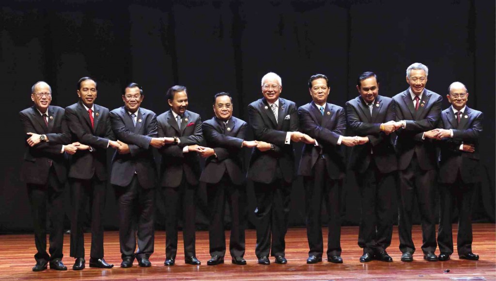 BAND OF ASEAN BROTHERS   Linking arms to signify unity and cooperation among member countries of the Association of Southeast Asian Nations, its leaders (from left) from the Philippines, Benigno Aquino III; Indonesia, Joko Widodo; Cambodia, Hun Sen; Brunei, Hassanal Bolkiah; Laos, Choummaly Sayasone; Malaysia, Najib Razak; Vietnam, Nguyen Tan Dung; Singapore,  Lee Hsien Loong;  Thailand, Prayut Chan-o-cha; and Burma,Thein Sein, pose for the traditional group photo at the opening ceremony of the 27th Asean Summit in Kuala Lumpur  on Saturday.   MALACAÑANG PHOTO BUREAU