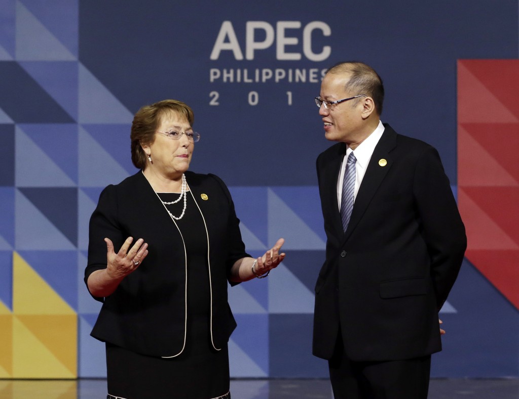 Chile's President Michelle Bachelet, left, is welcomed to the opening plenary session by Philippines President Benigno Aquino III  at the Asia-Pacific Economic Cooperation (APEC) Summit in Manila, Philippines, Thursday, Nov. 19, 2015. Asia-Pacific leaders called Thursday for increased international cooperation in the fight against terrorism as they held annual talks overshadowed by the Paris attacks. (Mast Irham/Pool Photo via AP)