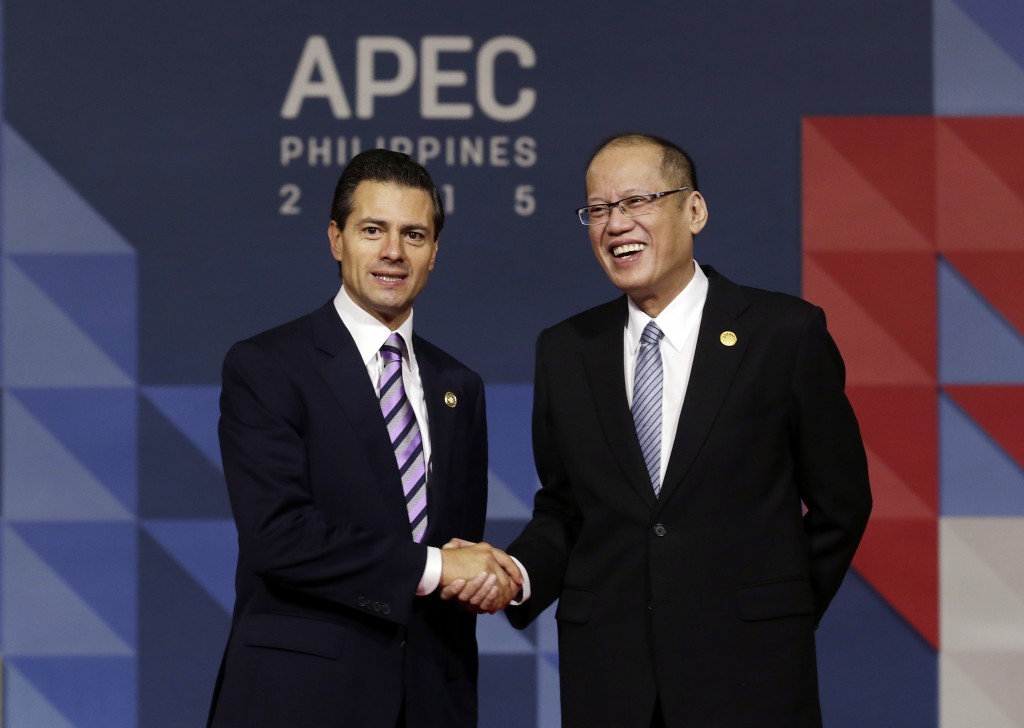 Mexican President Enrique Pena Nieto, left, is welcomed to the opening plenary session by Philippines President Benigno Aquino III  at the Asia-Pacific Economic Cooperation (APEC) Summit in Manila, Philippines, Thursday, Nov. 19, 2015. Asia-Pacific leaders called Thursday for increased international cooperation in the fight against terrorism as they held annual talks overshadowed by the Paris attacks. (Mast Irham/Pool Photo via AP)