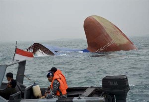 Indonesia rescuers approach a sunken freighter MV Thorco Cloud in the Singapore Strait off the Indonesian island of Batam , Thursday, Dec. 17, 2015. The freighter sank after colliding with a tanker on Wednesday. Rescuers have saved six crewmen from choppy waters while six others still missing. (AP Photo/Pangestu)