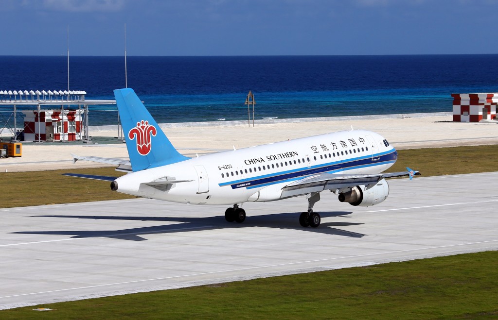 In this Wednesday, Jan. 6, 2016 file photo released by China's Xinhua News Agency, a China Southern Airlines jetliner lands at the airfield on Fiery Cross Reef, known as Yongshu Reef in Chinese, in the Spratly Islands, known as Nansha Islands in Chinese, of the South China Sea. An official says Philippine and U.S. foreign and defense chiefs will discuss new security concerns arising from China's completion of artificial islands in the disputed South China Sea, on Tuesday, Jan. 12 in Washington. AP