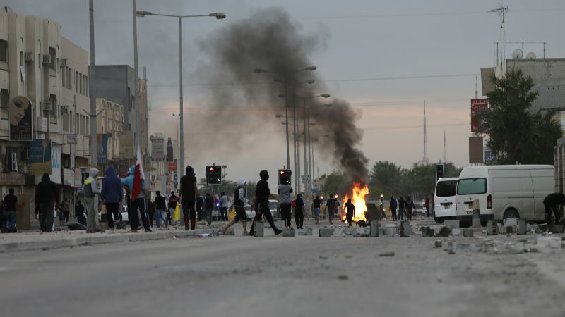 Bahraini protester clash with riot police during clashes in Sitra, Bahrain, Tuesday, Jan. 5, 2016. Protesters throwing petrol bombs and stones clashed with riot police firing tear gas and shot guns during a march against Saudi Arabia's execution of Shiite cleric Sheikh Nimr al-Nimr. (AP Photo/Hasan Jamali)
