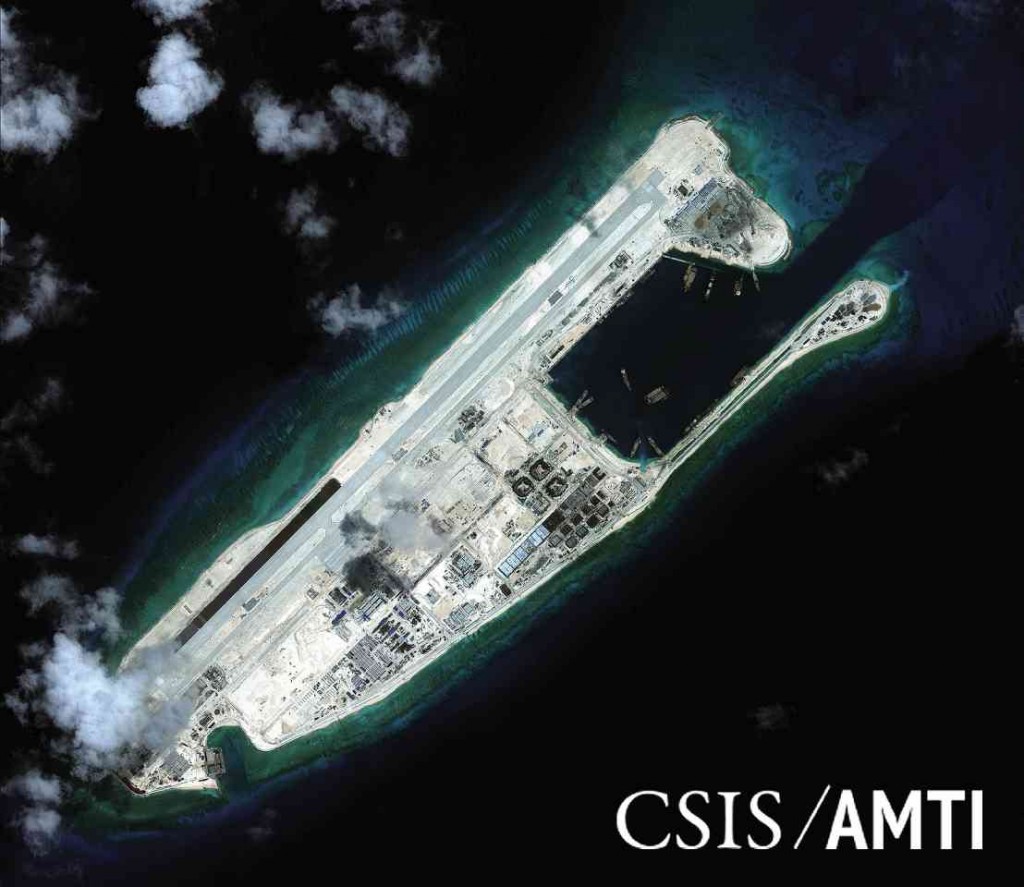 DISPUTED REEF  Photos provided by the Center for Strategic and International Studies show Kagitingan (Fiery Cross) Reef (above) with a 3,125-meter-long airstrip built by China and reclamation work (right) going on on the reef in the Spratly archipelago also claimed by the Philippines and Vietnam. REUTERS/CSIS/AFP/PAO 