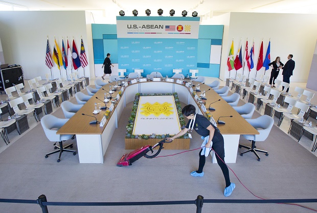 Maria Mendoza cleans and vacuums around the head table as last minute preparation are made at the Annenberg Retreat at Sunnylands in Rancho Mirage, Calif., site of today's meeting of ASEAN, the 10-nation Association of Southeast Asian Nations,  Monday, Feb. 15, 2016. President Barack Obama is hosting the ASEAN leaders, it is the first meeting of its kind on U.S. soil, as he looks to deepen ties with the region's fast-growing economies. (AP Photo/Pablo Martinez Monsivais)