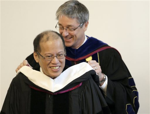 ‘MAN FOR OTHERS’ LoyolaMarymount University president Timothy Law Snyder confers an honorary doctorate on President Aquino in Los Angeles onWednesday. AP