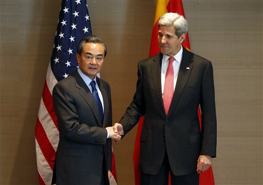  In this Feb. 12, 2016, file photo, U.S. Secretary of State John Kerry, right, shakes hands with China's  Froreign, Minister Wang Yi,  during a meeting in Munich, Germany, before the Munich Security Conference. The top diplomats of the U.S. and China meet Feb. 23, in Washington at a fraught time in relations between the two world powers. (AP Photo/Matthias Schrader, File)