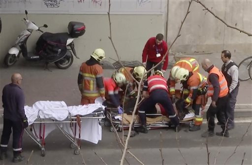 In this image made from video, emergency rescue workers stretcher an unidentified person at the site of an explosion at a metro station in Brussels, Belgium, March 22, 2016.   Explosions rocked the Brussels airport and the subway system Tuesday, just days after the main suspect in the November Paris attacks was arrested in the city, police said.(APTN via AP)