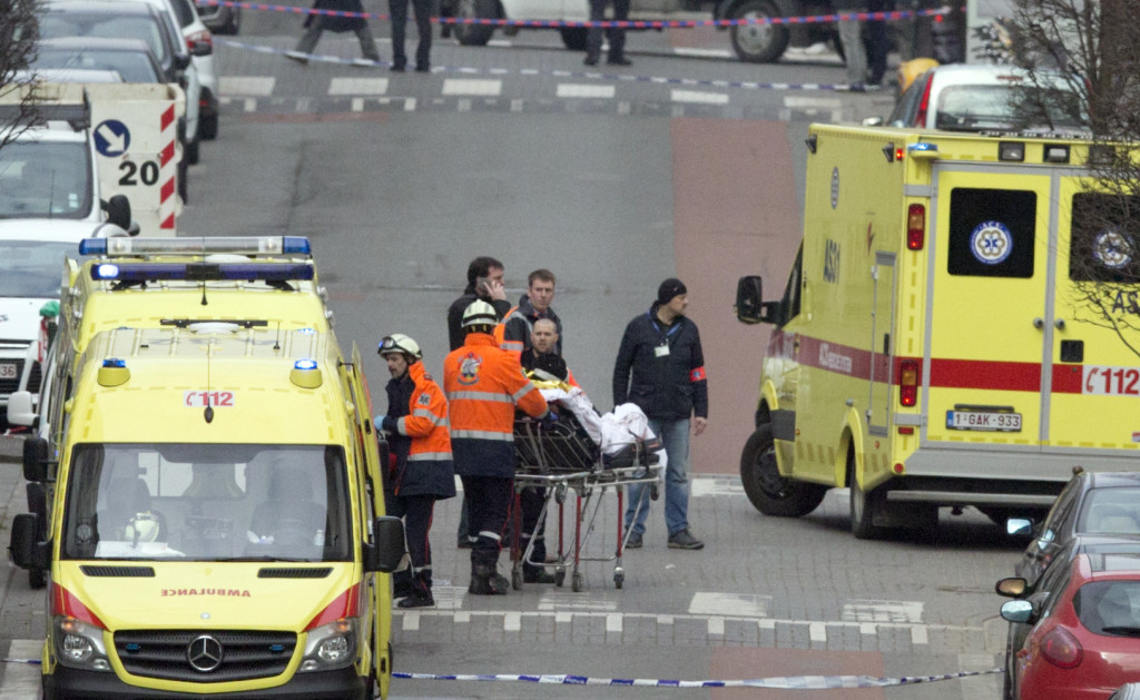 Emergency services evacuate a victim by stretcher after a explosion in a main metro station in Brussels on Tuesday, March 22, 2016. Explosions rocked the Brussels airport and the subway system Tuesday, killing at least 13 people and injuring many others just days after the main suspect in the November Paris attacks was arrested in the city, police said. (AP Photo/Virginia Mayo)