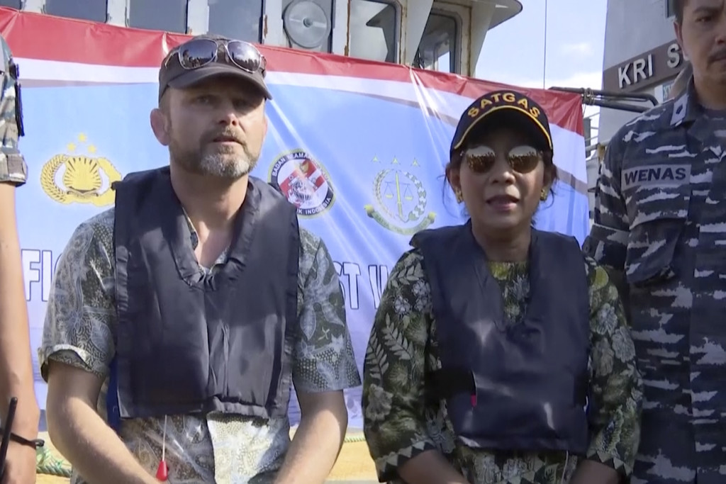 In this image made from video, Stig Traavik, left, Norwegian Ambassador to Indonesia, left, and Susi Pudjiastuti, Indonesia Maritime and Fisheries Minister, speak before illegal fishing vessel Viking, which was seized by Indonesia’s Navy, is sunk with explosives in the waters off Pangandaran, West Java, Indonesia, Monday, March 14, 2016. Indonesian authorities used explosives to sink the last major sought-after illegal fishing vessel on Monday after it had evaded international authorities for years, reiterating a strong message to would-be poachers that enter the country's waters. (AP Photo/APTN)