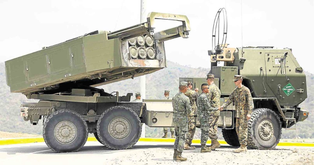 LONG-RANGE MISSILE SYSTEM Filipino and US soldiers stand in front of a US military M142 High Mobility Artillery Rocket System (Himars) launcher during the live fire exercise of Balikatan 2016 in Capas, Tarlac, on Thursday. Lyn rillon