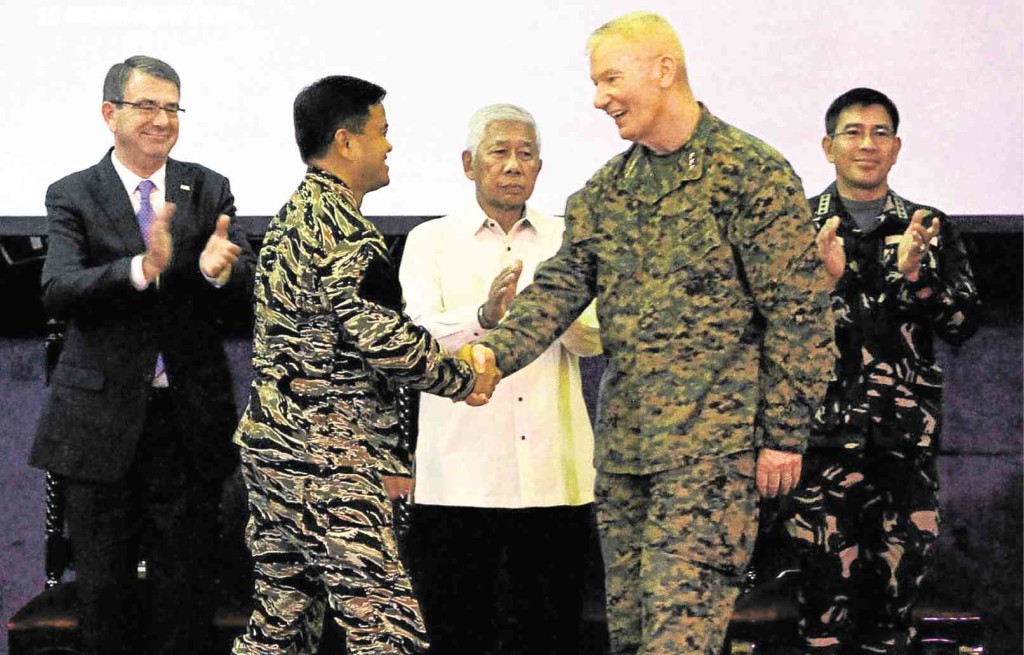 WAR GAMES END Philippine Navy Vice Adm. Alexander Lopez  and Lt. Gen. John Toolan of the US Marine Forces in the Pacific, the joint directors of Balikatan 2016, shake hands at the conclusion of the war games at Camp Aguinaldo, Quezon City, on Friday.  Behind are  Pentagon chief Ashton Carter  (left), Defense Secretary Voltaire Gazmin and AFP Chief of Staff Gen. Hernando Iriberri. RICHARD REYES 
