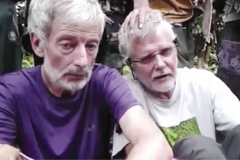 OUTRAGE  Canadians John Ridsdel (right) and Robert Hall are shown in this video grab sent earlier by the Abu Sayyaf to media outlets. MILITANT VIDEO VIA AP VIDEO
